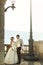 Sensual married couple bride and groom posing at sunset on balcony sea background