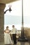 Sensual married couple bride and groom posing at sunset on balcony sea background