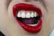 Sensual mouth with red lipstick, white teeth and fierce teeth.