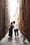 A sensual photo of two young people in a narrow street of the old city. Walk with a bike