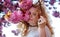 Sensual portrait of a sexy, smiling mature best age redhead woman in white dress behind pink flower tree blossoms in april, spring