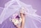 Sensual portrat of young beautiful bride holding flower bouquet