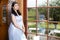 Sensual Relaxed Caucasian Brunette Female in Blue Wedding Dress With Tiara. Posing Indoors in Farm House