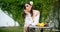 Sensual spring woman, banner for website header. Young sexy woman relaxing and eating orange fruit outdoor.