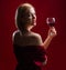 Sensual woman with glass of red wine. Beauty girl with wineglass. Sexy female drinks wine.