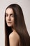 Sensual woman model with straight dark hair. Shiny long health hairstyle