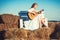 Sensual woman play guitar on wooden bench. Woman guitarist perform music concert. Albino girl hold acoustic guitar