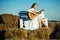 Sensual woman play guitar on wooden bench. Woman guitarist perform music concert. Albino girl hold acoustic guitar