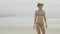 Sensual woman wearing colourful swimwear and wreath on a beautiful summer day at the beach