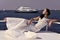 Sensual woman. Woman bride in wedding dress relaxing on yacht in sea