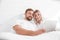 Sensual young couple together in bed. Happy couple in bedroom on a white background.