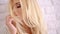 Sensual Young Female Touching her Long Blond Hair