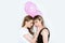 Sensual young girlfriends posing together and holding balloons isolated on grey