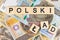 The sentence `Polski Åad` translated as  `Polish Order` and single Polish 500 PLN banknote on grey background..