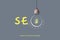 SEO concept. Search engine optimization. Glowing light bulb and word on a gray background