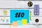 SEO inscription on a sheet lying on the desk. Search Engine Optimization. Creating more traffic on websites. Market analysis