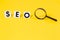 SEO search engine optimization logo ranking concept on a yellow background