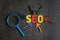 SEO, Search Engine Optimization ranking concept, magnifying glass with arrows pointing to alphabets abbreviation