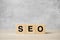 SEO Search Engine Optimization text wooden cube blocks on table background. Idea, Strategy, advertising, marketing, Keyword and