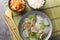 Seogogi Mu Guk Korean Beef and Radish Soup served with rice and kimchi closeup on the mat on the table. Horizontal top view