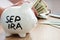 SEP IRA written on a side of piggy bank. Pension plan.