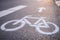 Separate bicycle lane for riding bicycles. A white bicycle symbol on the road. Selective focus