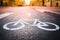 Separate bicycle lane for riding bicycles. A white bicycle symbol on the road. Selective focus