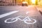 Separate bicycle lane for riding bicycles. A white bicycle symbol on the road. Selective focus