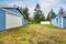 Separate garage with blue trim and white door