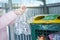 Separate garbage collection. Girl throws plastic bottles in a container for recycling