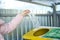 Separate garbage collection. The girl throws plastic bottles in a container for recycling plastic