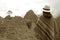 Sepia Image of Female in Poncho Looking at the Amazing Inca Ruins of Machu Picchu, Cusco Region, Peru