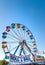 Sept. 2, 2012 - Vancouver, Canada: Colourful fairground ferris wheel and midway at PNE fair on a sunny afternoon.