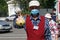 September 02, 2020, Russia, Magnitogorsk. A salesman at a seasonal street vegetable fair shows off a turnip with a funny face