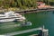 September 14, 2018 - Juneau, Alaska: Fishing boat departing harbor past yacht.