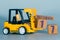 september 17th. Day 17 of month, Construction or warehouse calendar. Yellow toy forklift load wood cubes with date. Work planning