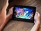 September 2019 Parma, Italy: Clash of clans game on tablet in kid`s hands close-up. Clash of clams app