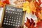 September 2023 monthly calendar with maple leaf on wooden background