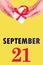 September 21st. Festive Vertical Calendar With Hands Holding White Gift Box With Red Ribbon And Calendar Date