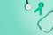 September Ovarian cancer Awareness month, teal Ribbon with stethoscope for supporting people living, and illness. Healthcare and