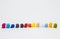 Sequence column of colorful button on white background and selective focus