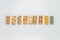 Sequence of wooden dominos on white background with selective focus