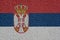 Serbia Politics Or Business Concept: Serbian Flag Wall With Plaster, Texture
