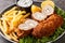 Serbian Breaded Rolled Cutlet Karageorge Schnitzel with french fries and tartar sauce close-up in a plate. Horizontal