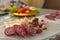 Serbian breakfast with sliced domestic sausage, bacon, ham and cheese.