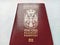 Serbian passport. New biometric document for border crossing. Official documentation. Red and burgundy passport crusts with shiny