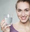 Serene 20s girl showing glass of fresh tap or mineral water