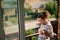 Serene African American woman enjoying coffee break on balcony at morning