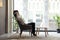 Serene african businesswoman resting sitting on armchair in office lobby