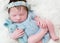 Serene baby dressed in blue costume, closeup